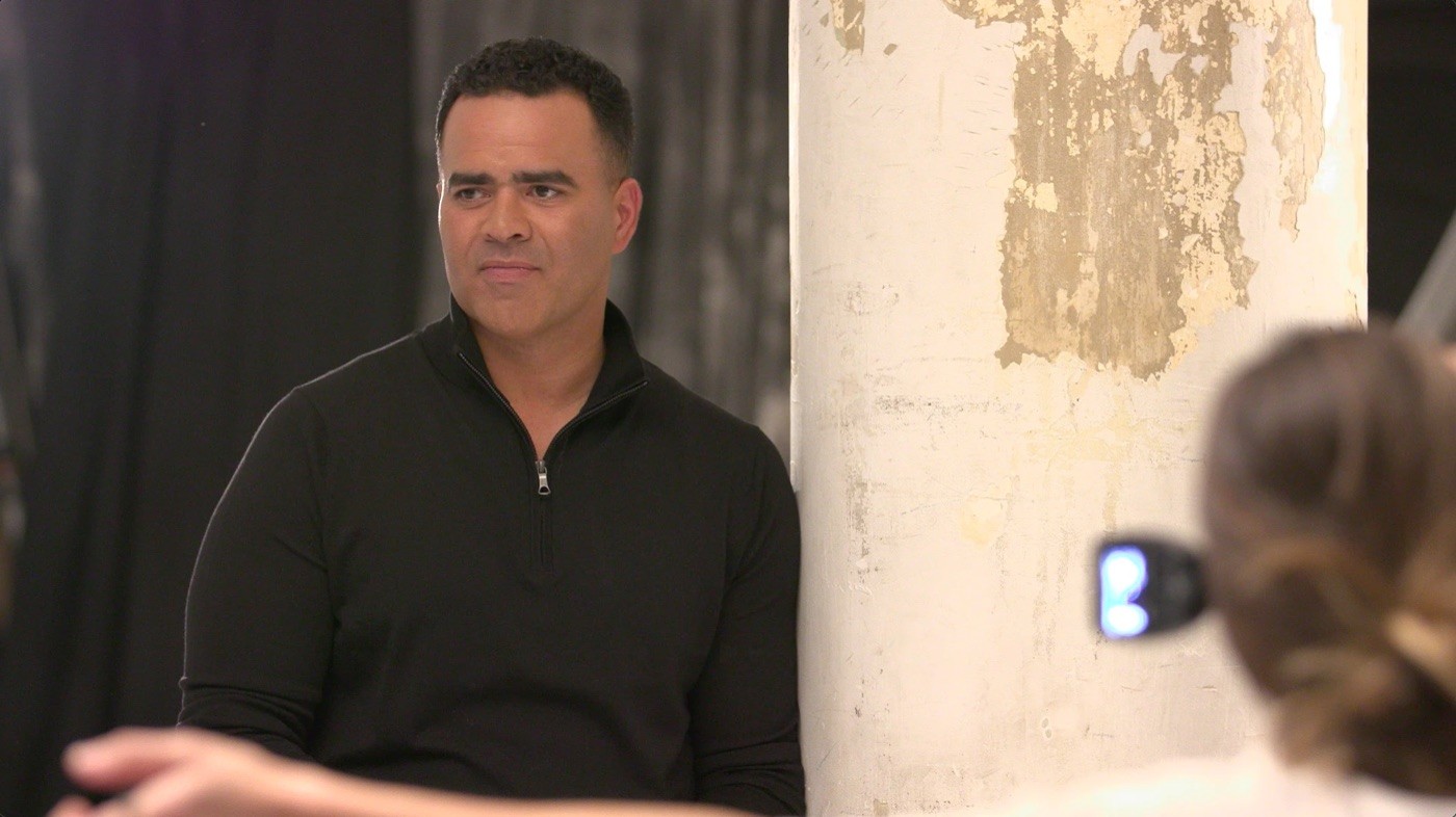 Christopher Jackson in a black quarter-zip sweater