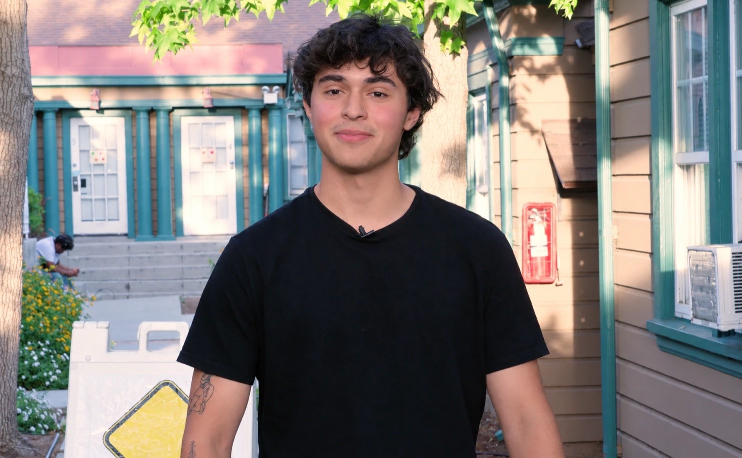 An AMDA acting student smiling to camera outdoors on campus