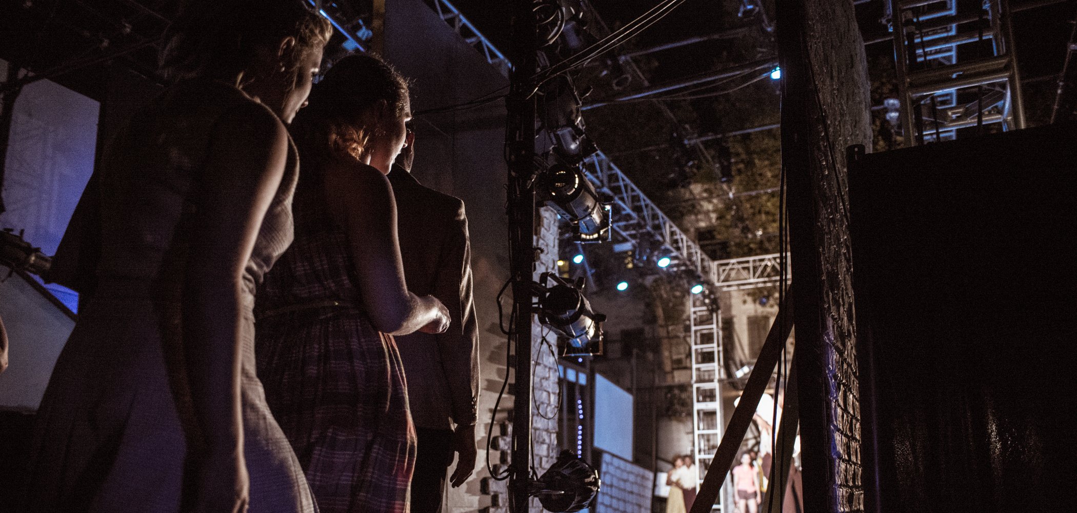 Three students wait to go onstage during a production at AMDA Los Angeles