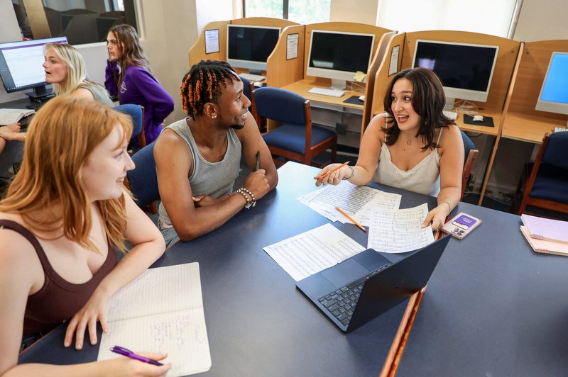 A diverse group of AMDA students in discussion in the Performing Arts Library