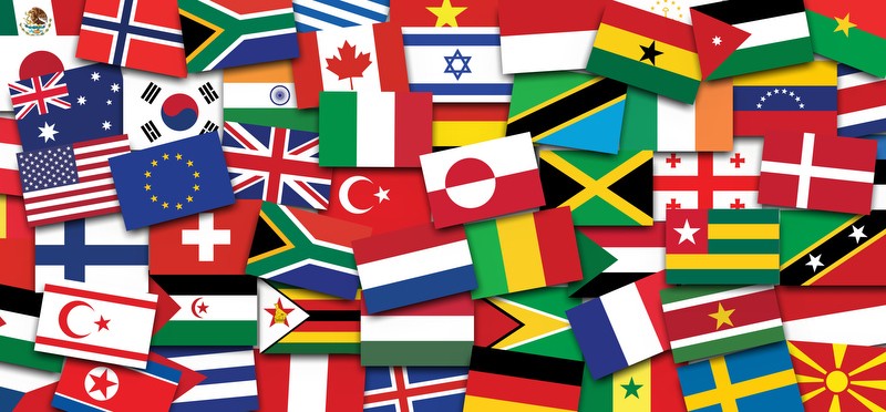Collage of flags of many nations casually arranged